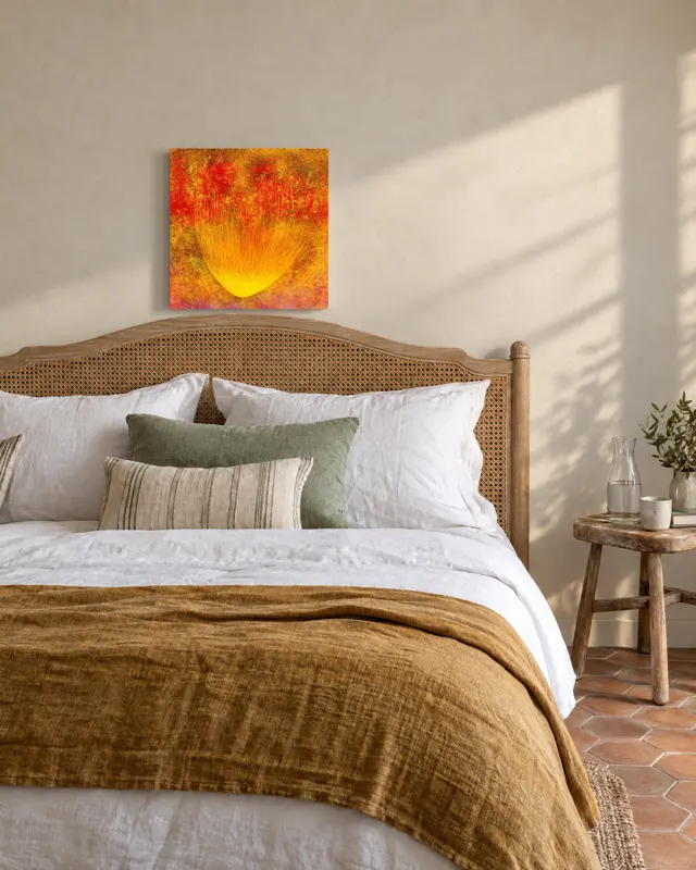 A painting above a cane bed